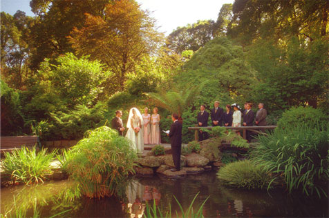 Wedding party next to pond, Fitzroy Gardens.