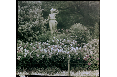 Statue in garden flower bed