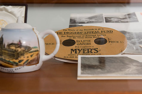 Ceramic teapot with painted scene, four black-and-white photos and Diggers’ fundraiser product from Myer’s