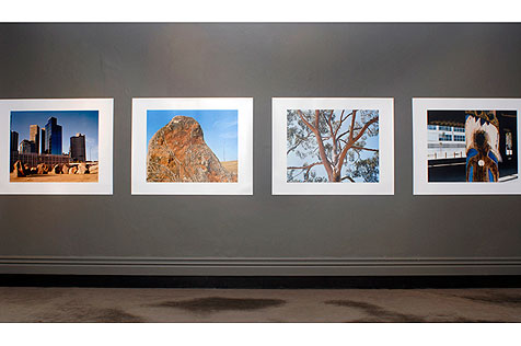 Four photographs arranged horizontally on the wall