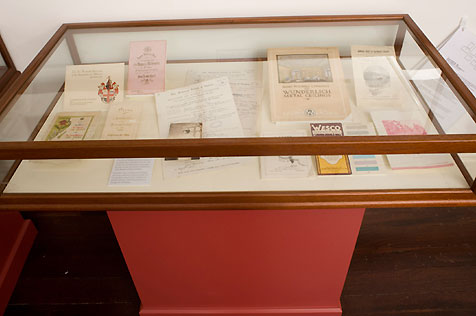 Display case containing several items of paper ephemera
