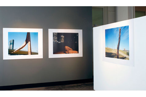 Corner of the gallery featuring three photographs.