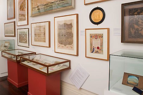 Gallery interior showing display cases and artworks from Community Treasures