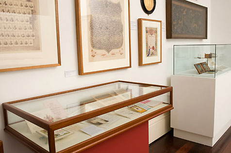 Glass-topped display case containing artefacts from Community treasures