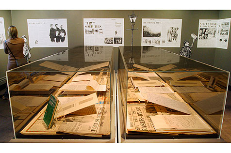 Glass exhibit cases with old newspapers