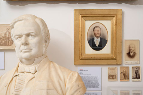 Close-up of a white bust, and sepia photographs of men