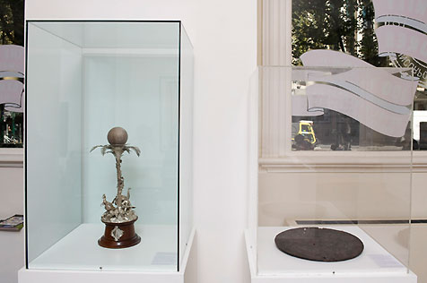 Glass display case on left with emu egg on ornate silver and timber stand