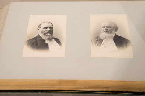 Close-up of two sepia photographs featuring headshots of men