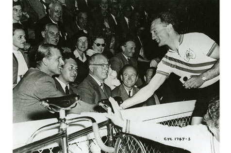 The Duke of Edinburgh congratulates Australian cyclist Dick Ploog, after he beat Bill Johnston (NZ) for the bronze medal in the 1000m sprint at the velodrome
