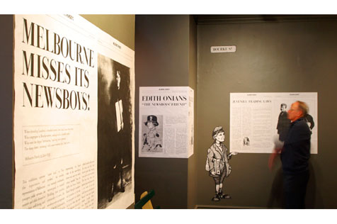 Man looking at Melbourne newsboys exhibits