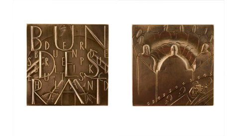 Back and front of square metal medal