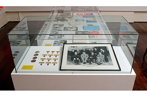 Glass display case with badges  and photo