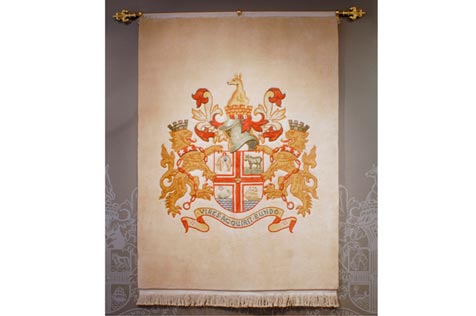 Woolen rug with a yellow and orange coat of arms