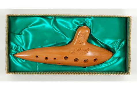 Clay ocarina in a presentation box lined with green fabric