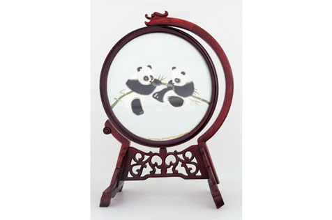 Silk embroidery of two pandas in a round wooden frame and stand