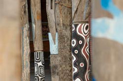Close-up of wooden poles decorated with Aboriginal motifs