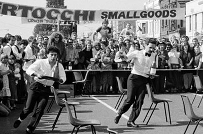 People participating in a waiter's race carrying food and drink