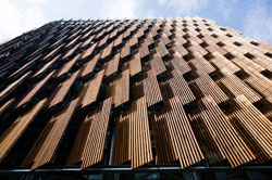 Upward view of the timber-shuttered building facade