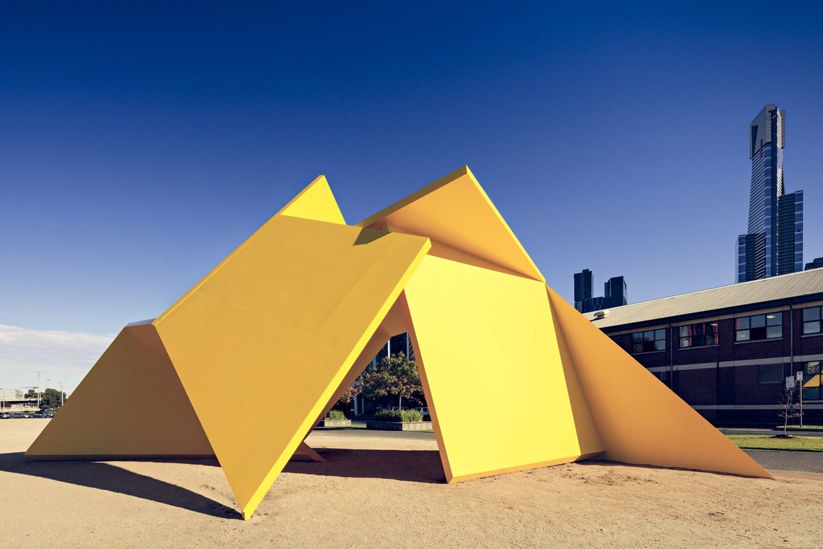 Photograph of large yellow geometric outdoor sculpture near the Melbourne CBD