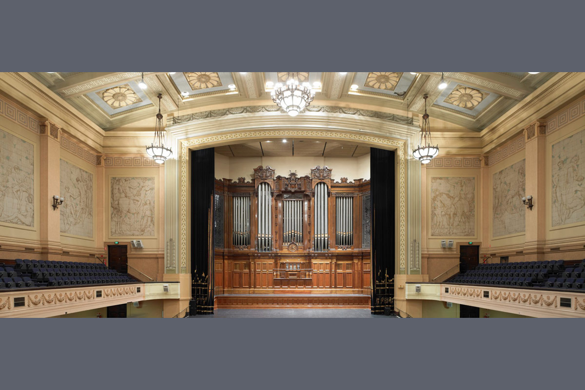 Photo of showing the murals on either side of the grand organ in the town hall auditorium