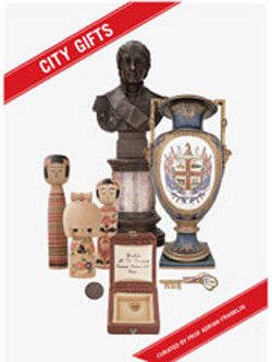 City Gifts exhibition catalogue  cover featuring elaborate vase, bust, wooden dolls, coin, presentation box and key