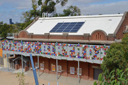 Building with white rooftop and solar panels