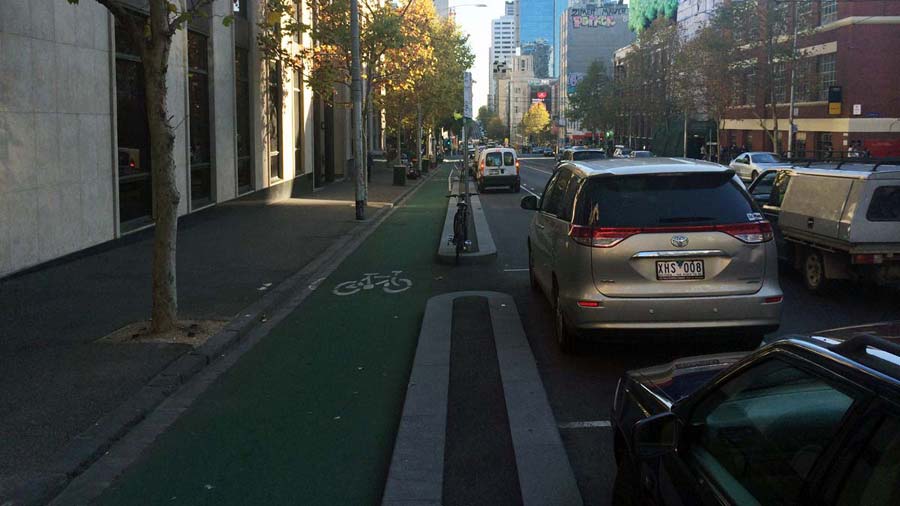 The bike lane on La Trobe street, alongside the kerb and physically separated from parked cars on the right.