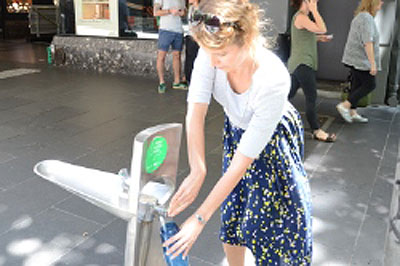 Woman filling water bottle at fountain