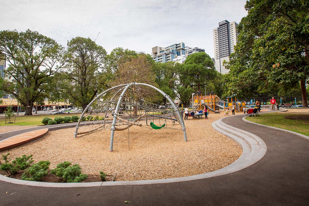 Children's playground in Flagstaff Gardens with rope climbing frame, swings and other play equipment.