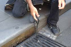 Hand lowering cable into a drain