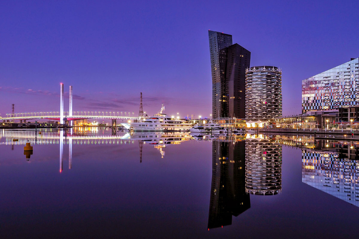 Melbourne City Marina at dusk with the Bolte Bridge and buildings reflected in the water