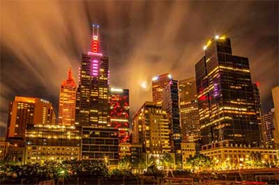 Melbourne CBD buildings lit up at night 