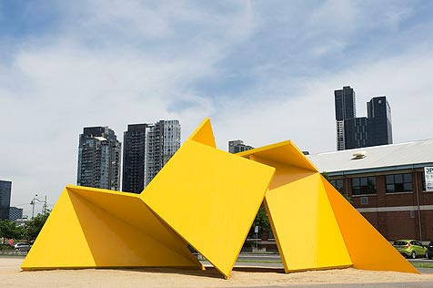 Yellow origami-like steel sculpture