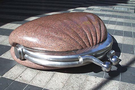 Red-granite and stainless-steel sculpture of purse