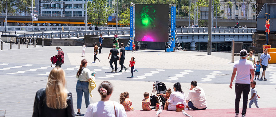Public open space with people and screen