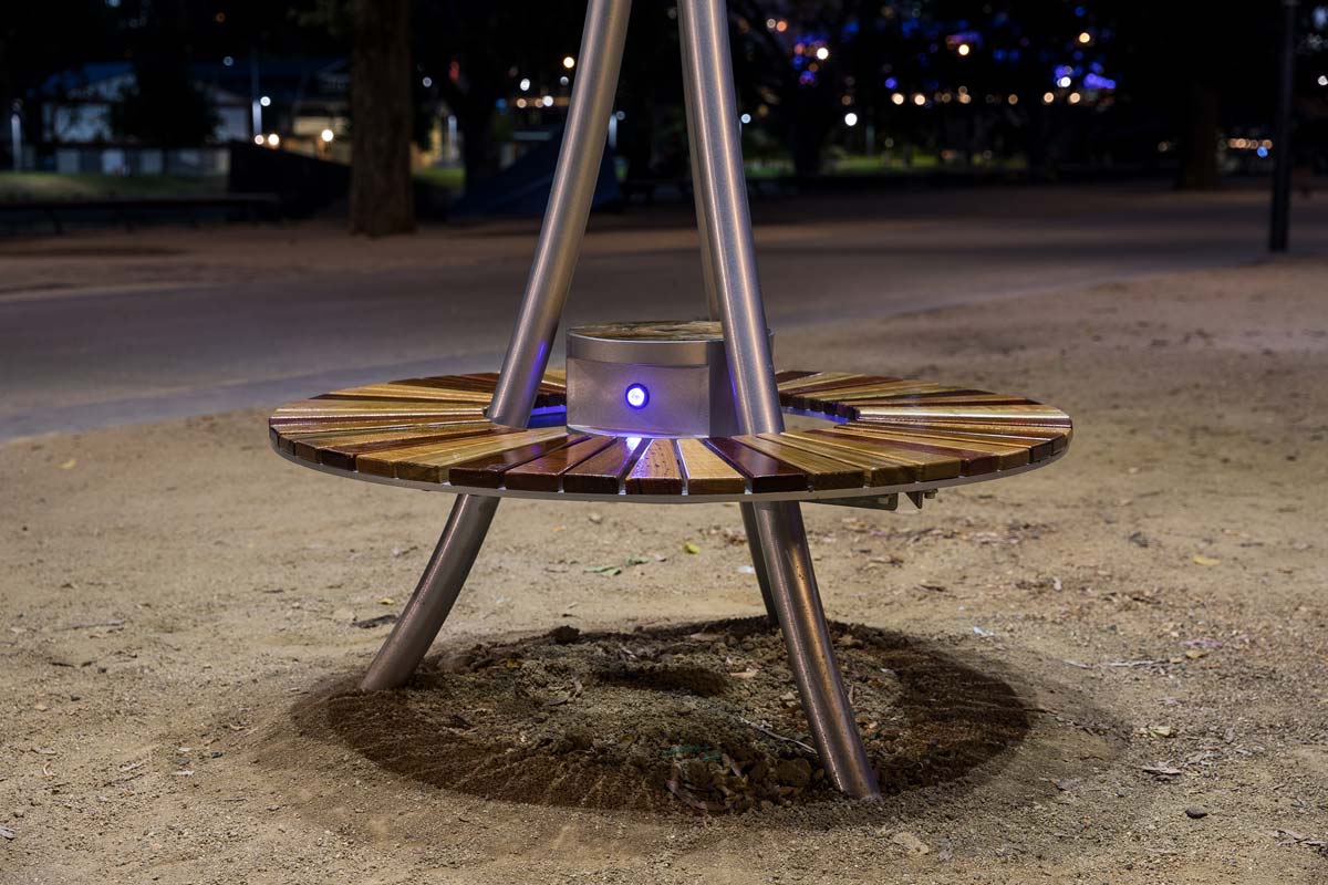The solar tree's bench casting a shadow on the ground