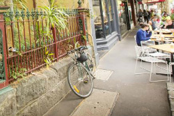 Bike and cafe tables/chairs on a footpath