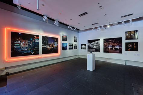 Corner of the gallery with walls covered with large photographs