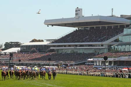 Horse race with large crowd of spectators at Flemington Racecourse