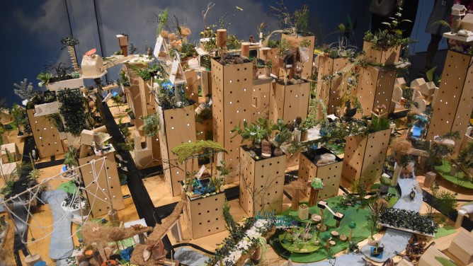 A model city with cardboard buildings, plants and roads