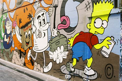 Street art of Bart Simpson riding a skateboard with a spraypaint can, being chased by assorted cartoon characters.