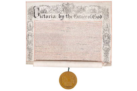 Page headed 'Victoria by the grace of God' with writing on it and a medal hanging down
