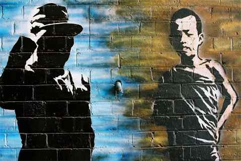 Painting of two men, one in silhouette, on a brick wall.