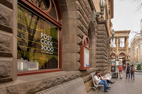 External view of Melbourne Town Hall with advertising for Postcode 3000 exhibition