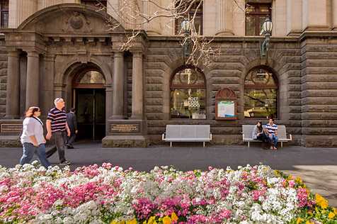 External view of Melbourne Town Hall with flowers in the foreground
