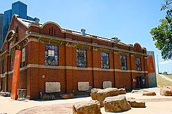 A red brick building with boulders in front of it.