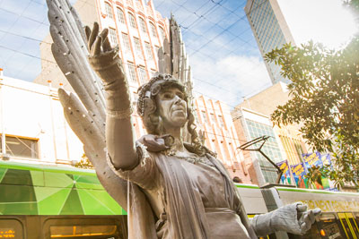 Busker performing as an angel statue