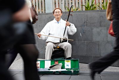 Busker playing a traditional Chinese stringed instrument