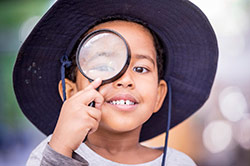 A young boy with a magnifying glass