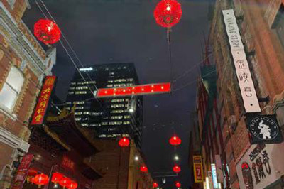 Chinese lantern-style lights with tall buildings in background